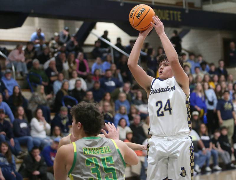 Marquette's Matt Graham lets go of a shot over Seneca's Zeb Maxwell on Friday, Feb. 21, 2025 in Bader Gym at Marquette Academy.