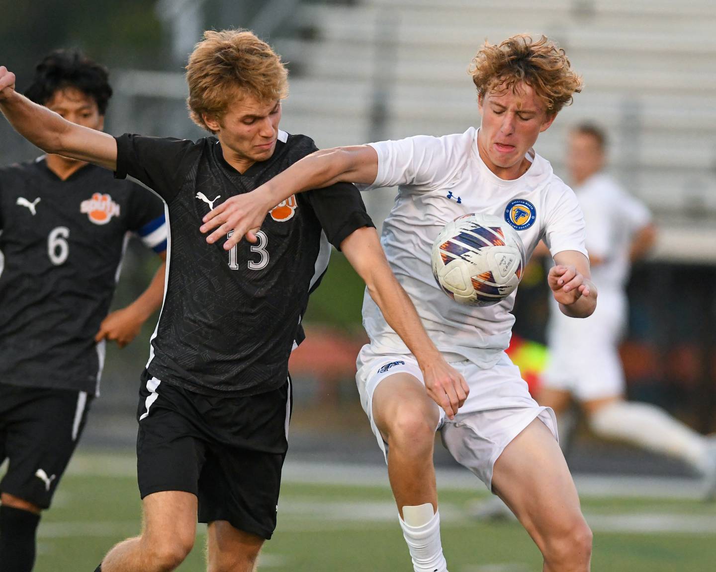 Wheaton Warrenville South's Noah Giannasi (13) and Wheaton North's Rocco Johnson (10) battle for the ball during the game on Thursday Sept. 11, 2025, held at Wheaton Warrenville South.