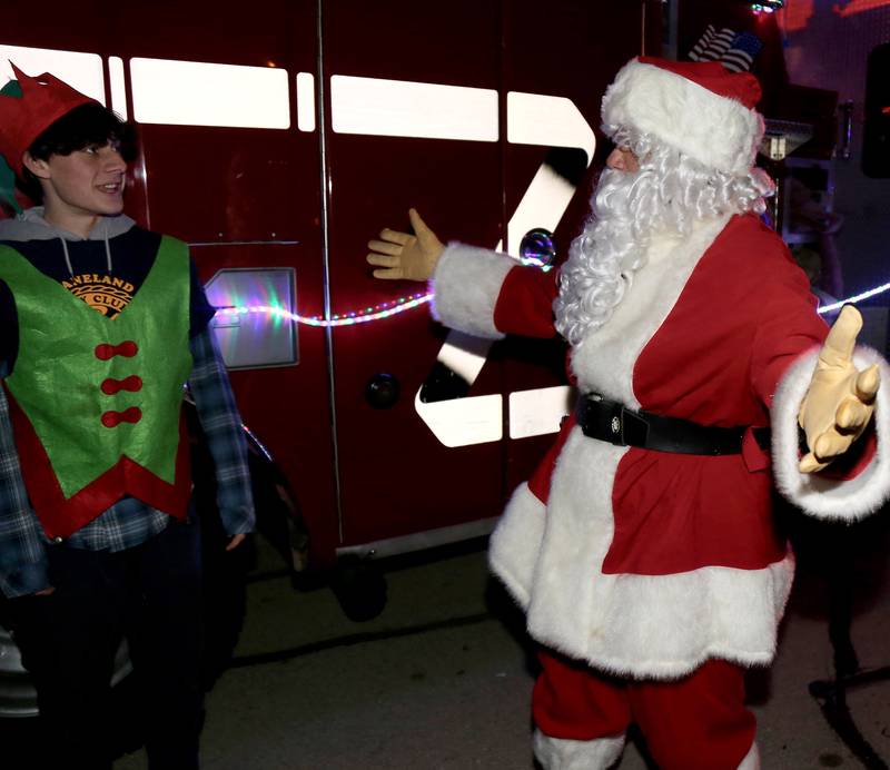 Santa gets ready to hug one of his Kaneland High School Key Club elves at the Sugar Grove Holiday Tree Lighting Ceremony on Friday, Dec. 6, 2024.