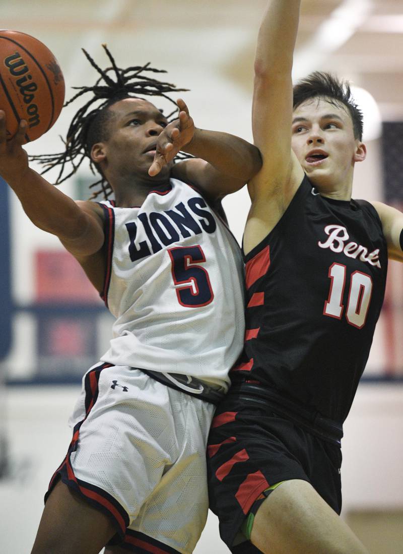 Saint Viator’s Dayvion Ellis is fouled by Benet Academy’s Andy Nash in a boys basketball game in Arlington Heights on Tuesday, January 17, 2023.