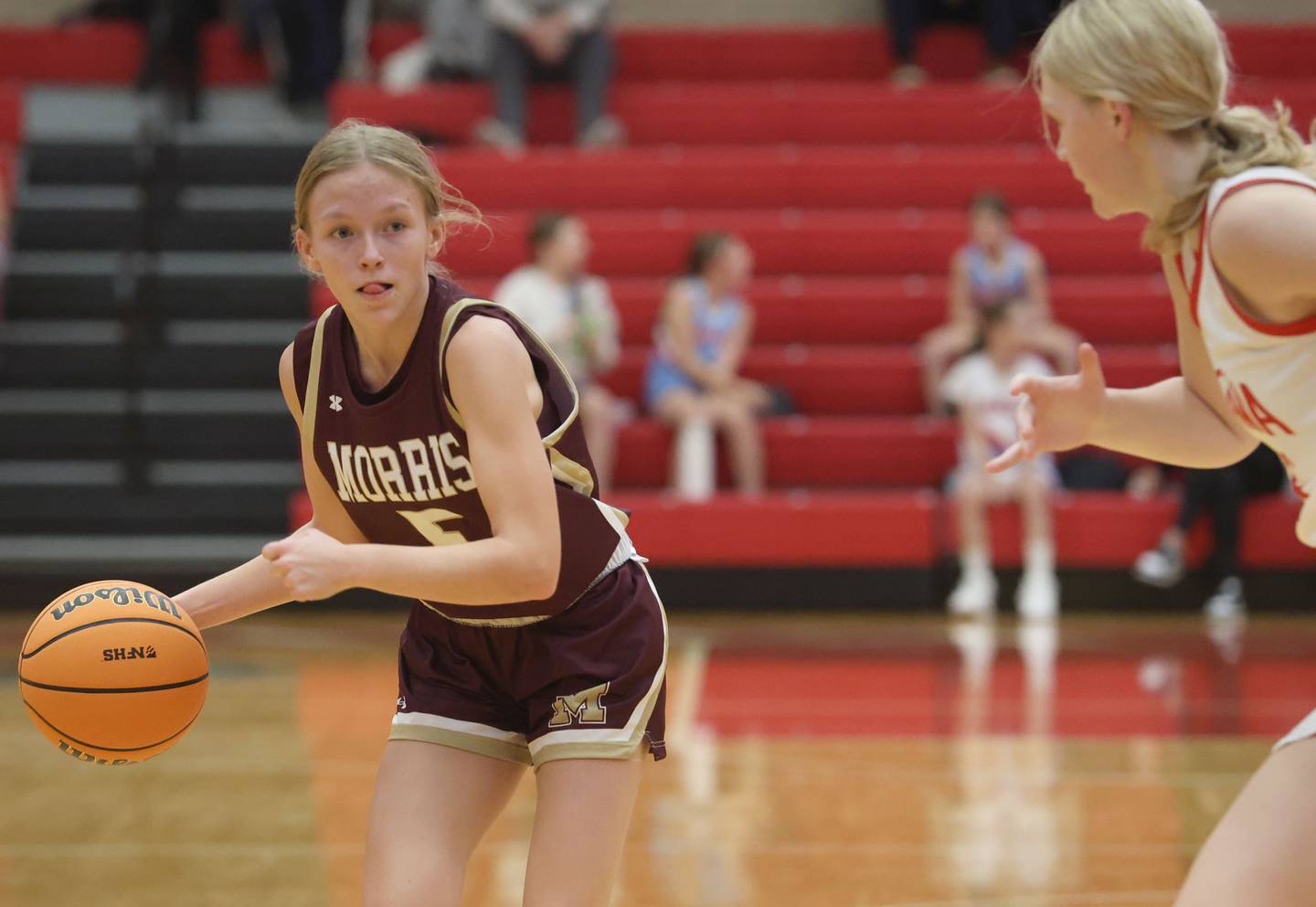 Morris's Ava Petersen looks to pass the ball off around Ottawa's Libby Muffler on Tuesday, Dec. 9, 2025 in Kingman Gymnasium at Ottawa High School.