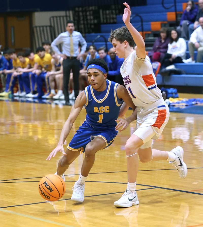 Aurora Central Catholic's Marcus McGill tries to get around Genoa-Kingston's Kash Sunderlage Monday, Feb. 23, 2026, during their IHSA Class 2A regional quarterfinal at Genoa-Kingston High School.