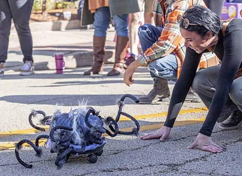 Jaclyn Sciacero of Sterling gives her spider racer a nudge after it failed to fire off the line during the pumpkin derby at Scarecrow Fest Saturday, Oct. 21, 2023 in Dixon. Sciacero opting for beauty over performance, still enjoyed the race day activity.