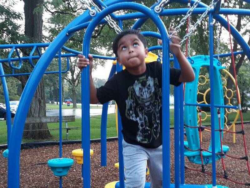 Javon Johnson, 7, plays on the new playground by the Algonquin Road School on Tuesday following a ribbon cutting ceremony.