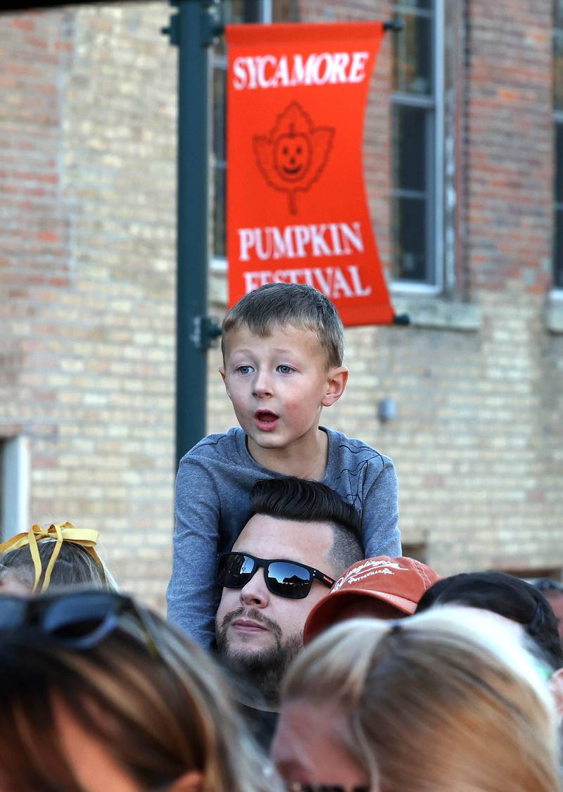 Some visitors are excited for a treat during the cake cutting ceremony Wednesday, Oct. 23, 2024, near the DeKalb County Courthouse during the Sycamore Pumpkin Festival. The cake was donated by the Sycamore Hy-Vee.