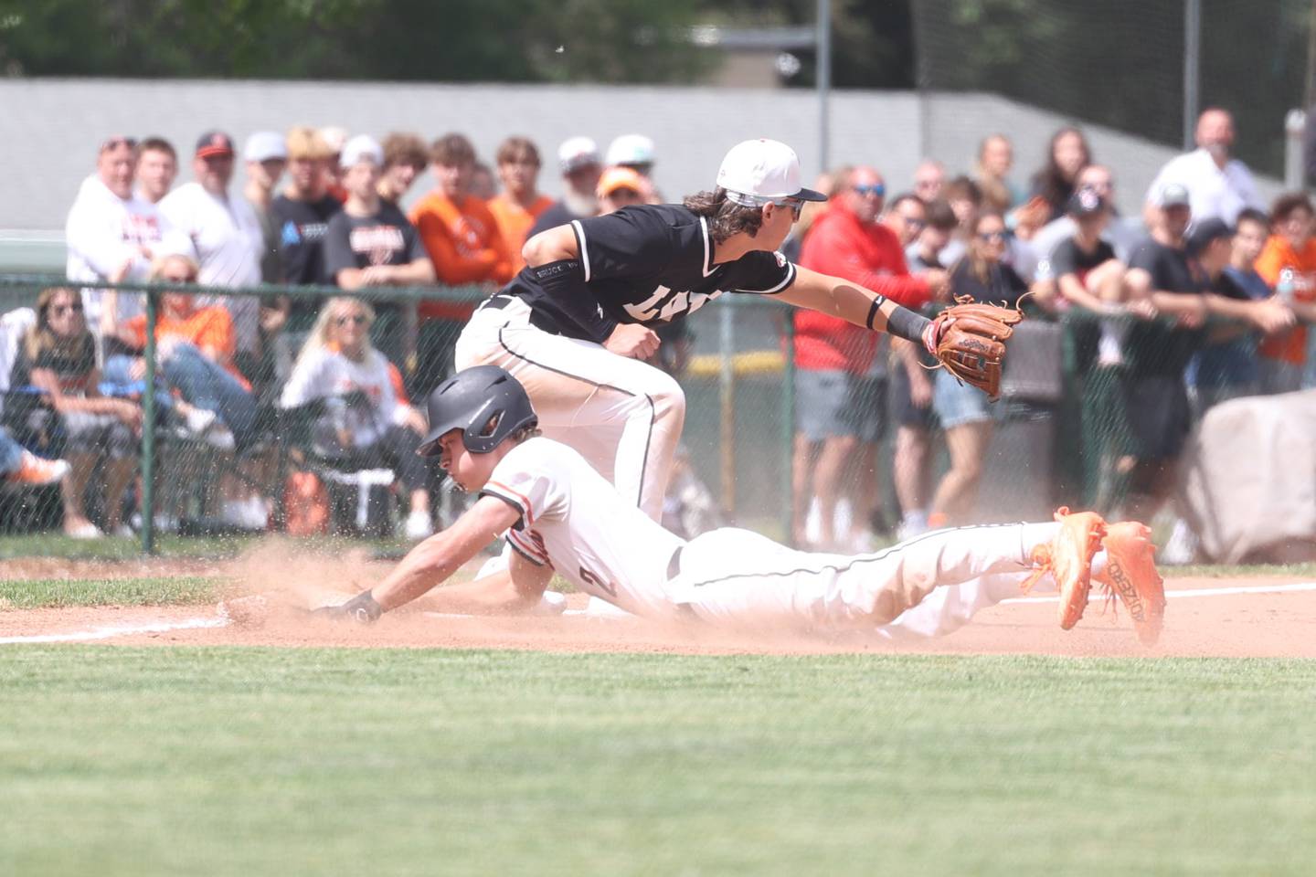Lincoln-Way West’s Braden Erwin slides into thirst ahead of the throw against Lincoln-Way Central in the Class 4A Providence Sectional semifinal on Wednesday, May 29, 2024 in New Lenox.