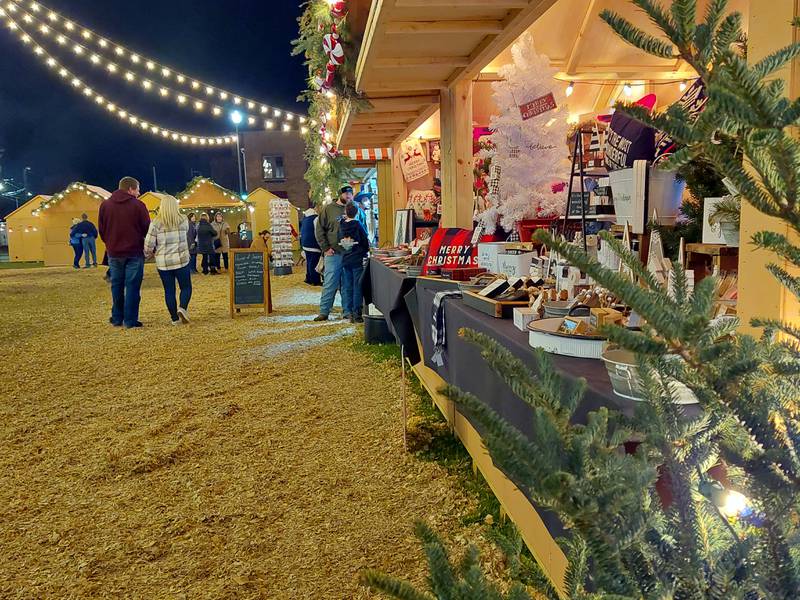 Shoppers peruse items at the Chris Kringle huts Friday, Dec. 15, 2023, at the Jordan block in Ottawa. Saturday and Sunday are the final days of the four-weekend market.