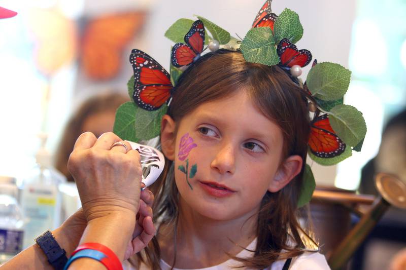 Leana Pickett, 8, of Lake in the Hills has her face painted during Monarchs and Music at Crystal Lake Main Beach Sunday.