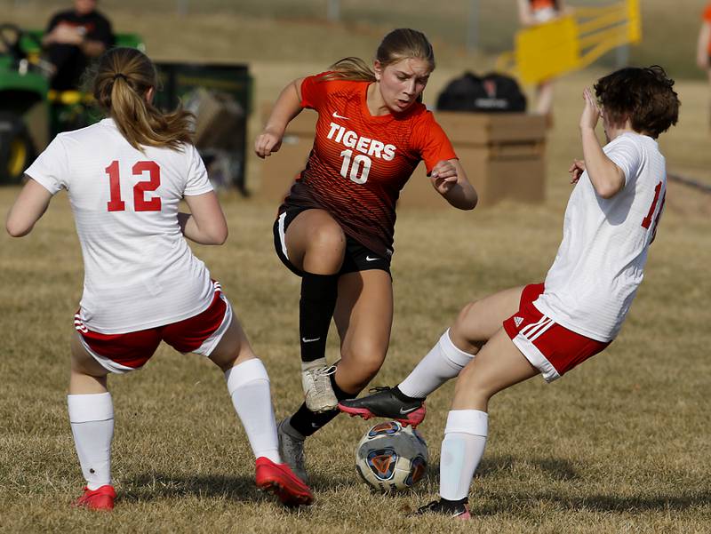 Crystal Lake Central's Brooklynn Carlson moves the ball between the defense of Marian Central's Abbey Miner, left, and Mia Knapp. right, during a non-conference soccer match Monday, March 21, 2022, between Crystal Lake Central and Marian Central at Crystal Lake Central High School.