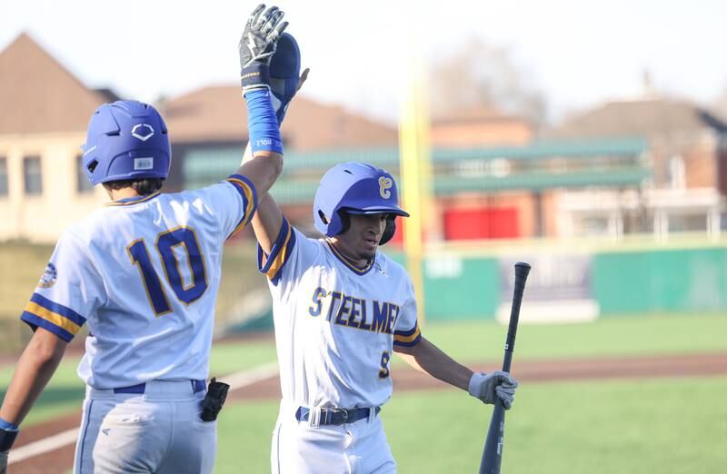 Joliet Central’s Nathan Maldonado is greeted with a high-five after scoring against Aurora East on Monday, Mar. 11th in Joliet.