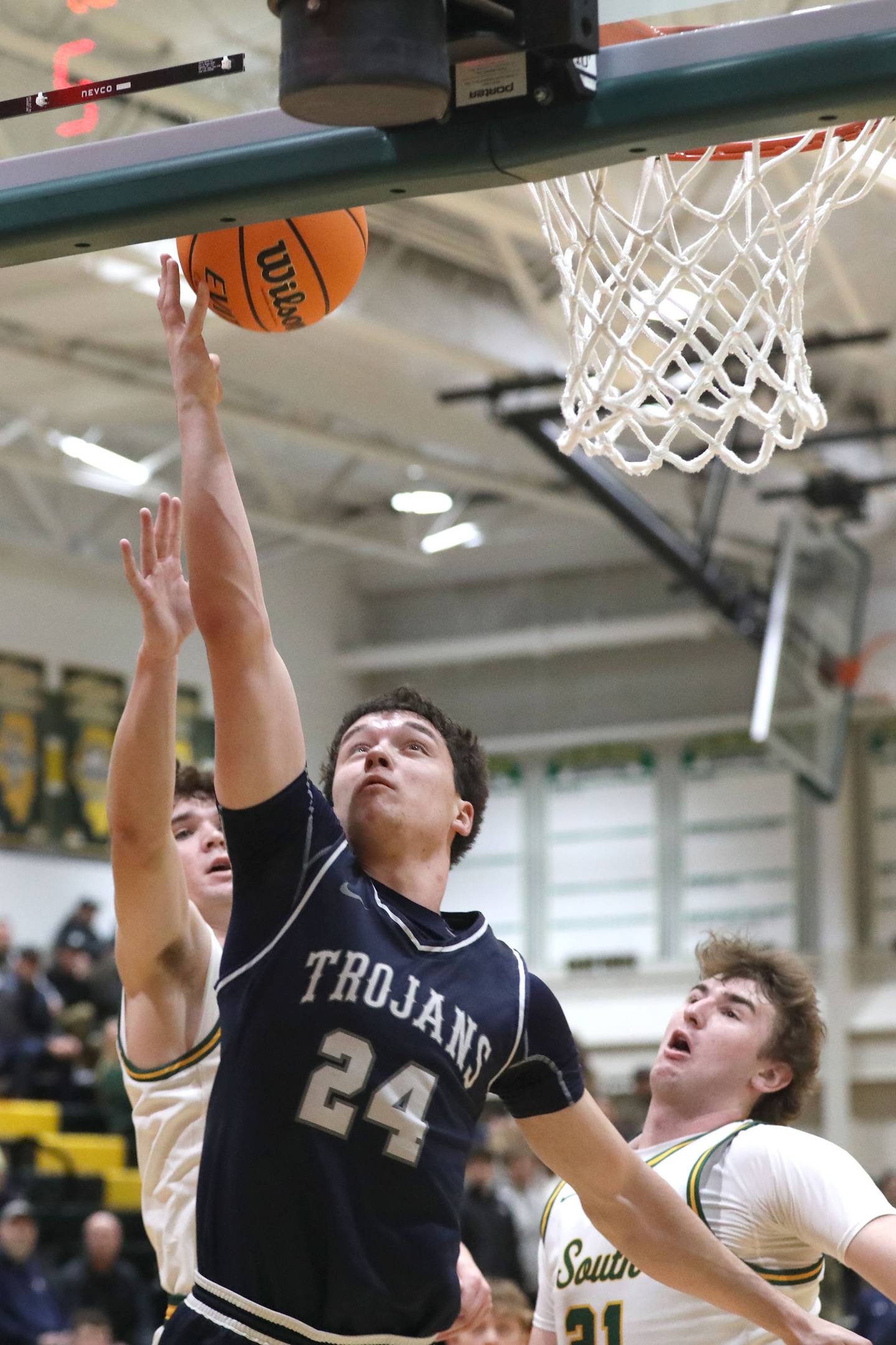 Cary-Grove's Brady Bauer (center) shoots the basketball in front of Crystal Lake South's Nick Stowasser (left) and Crystal Lake South's Ryan Morgan (right) during a Fox Valley Conference boys basketball game on Friday, Jan. 23, 2026, at Crystal Lake South High School.