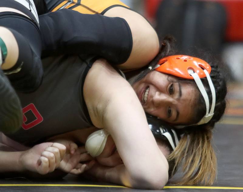 McHenry’s Natalie Corona, top, battles Ella Cooper of Oswego East at 145 pounds in the title bout of varsity girls IHSA Sectional wrestling on Saturday, February 14, 2026, at Schaumburg High School in Schaumburg.