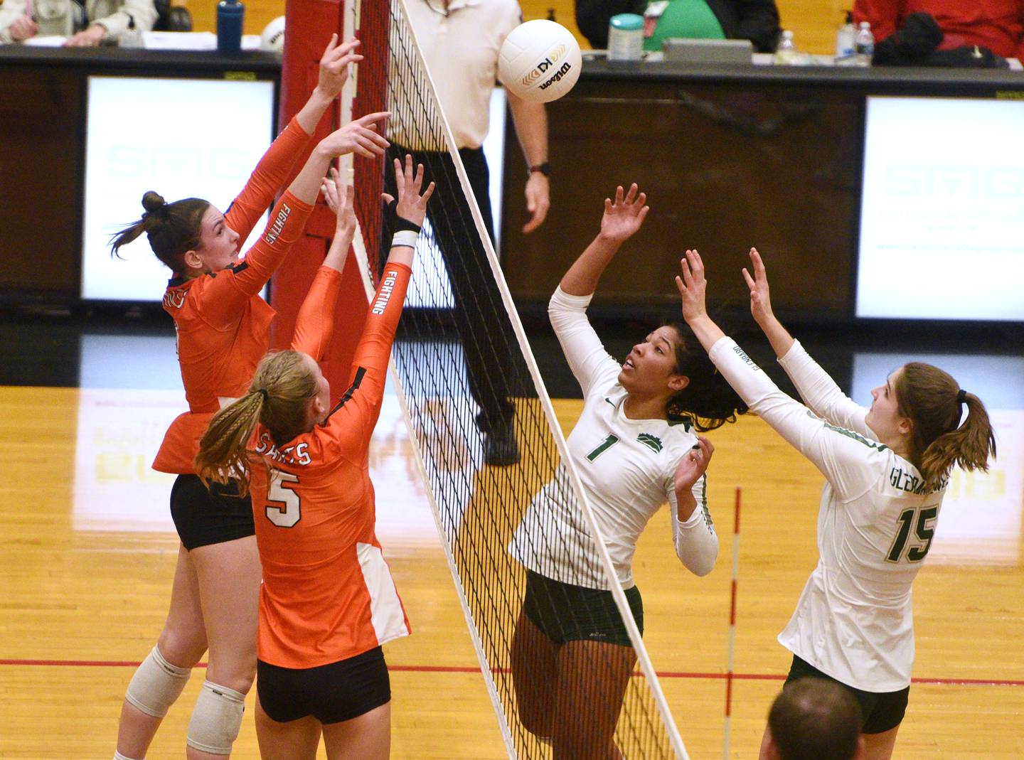 Paul Valade/pvalade@dailyherald.com
St. Charles East's Sarah Musial (5) meets at the net with Glenbard West's Haydon Green (1) during Monday’s Proviso West Class 4A girls sectional volleyball match in Hillside.