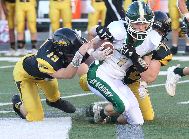 St. Bede's Alex Ankiewitz is brought down by Tuscola's JJ Reynolds and Caiden Russo on Friday, Aug. 25, 2023 at Tucci Stadium  in Bloomington.
