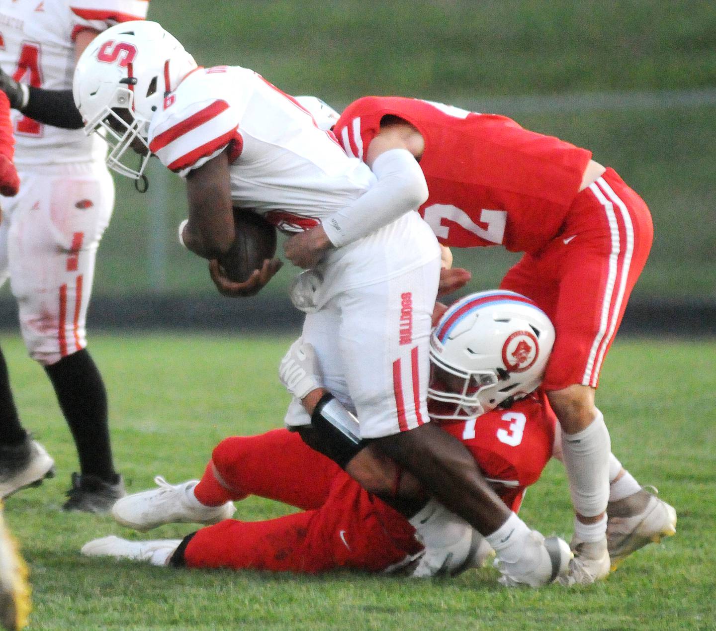 Ottawa defenders Ethan Poutre (13) and Joey Liebhart take down Streator ball carrier Leodies Jordan on Friday, Sept. 5, 2025 at King Field.
