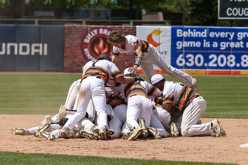 The team mobs McHenry's Ricky Powell (22) after hitting the game winner to defeat York in the Class 4A Supersectional game.  June 7, 2022.