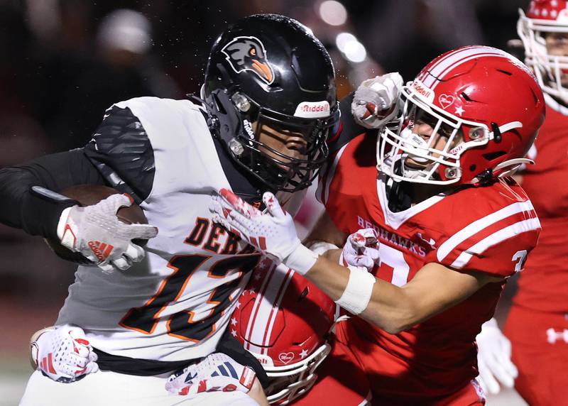 DeKalb’s Davon Grant tries to fend off Naperville Central's Aidan Sheehy after a catch during their game Friday, Oct. 6, 2023, at Naperville Central High School.