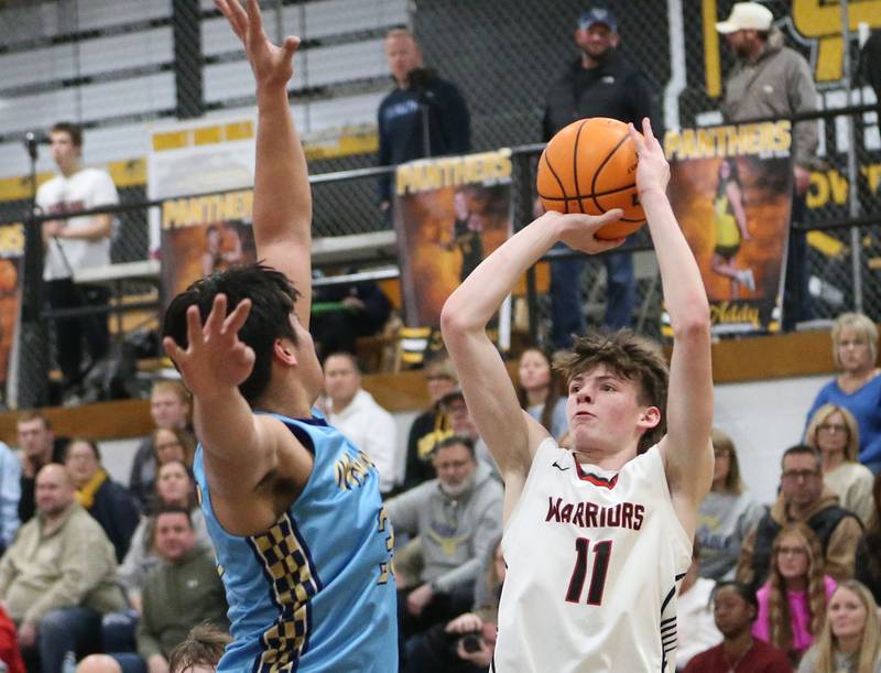 Woodland's Nate Berry shoots a jump shot over Marquette's Blayden Cassel during the Tri-County Conference Tournament championship on Friday, Jan. 30, 2026 at Putnam County High School.
