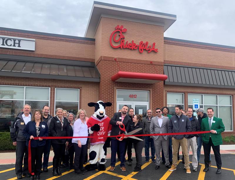 Roger Deutscher, the new owner of Chick-fil-A in Crystal Lake, cuts the Ribbon to celebrate along with the crew of Chick-fil-A, and the staff and board members of the Cary-Grove Area Chamber of Commerce and Crystal Lake Chamber of Commerce.