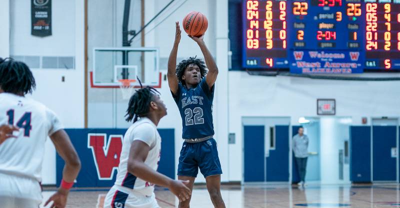 Oswego East's Jehvion Starwood (22) shoots a three-pointer against West Aurora during a basketball game at West Aurora High School on Friday, Jan 27, 2023.