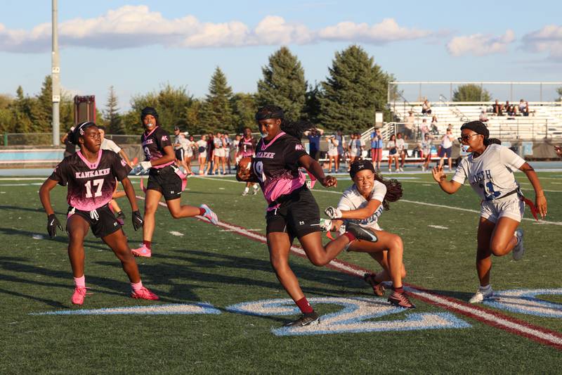 Kankakee quarterback London Stroud evades Plainfield South's Simone Miller to run for a touchdown during the Kays' 40-26 victory over Plainfield South on Monday, Oct. 6, 2025.