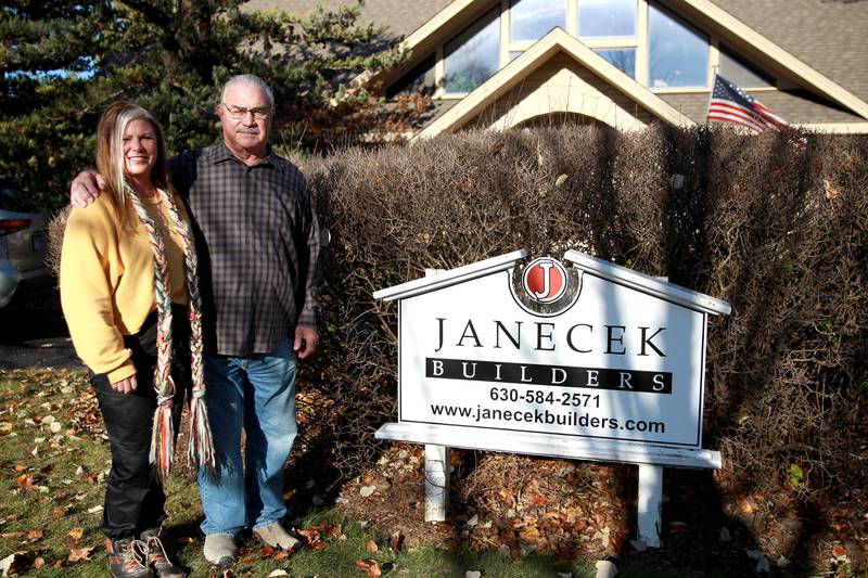 Caroline Janecek Korakis and her father, Bill, outside Janecek Builders, a family business in St. Charles. Bill is passing ownership to his daughter, who is changing the business model from custom home construction to custom remodels and renovations.