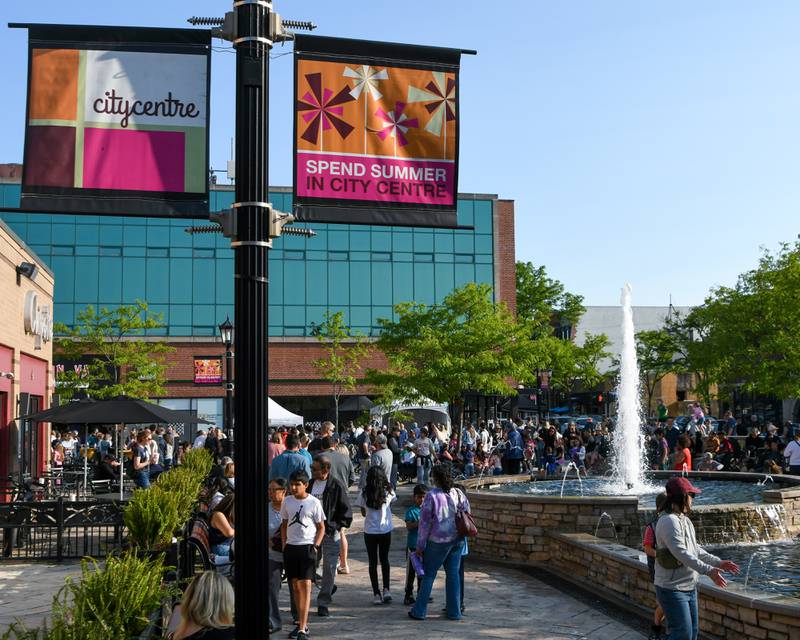 Community members enjoy the weather and fountain on Saturday May 31, 2025, during the Elmhurst Summer Kick Off Party held at City Centre Fountain Plaza in Elmhurst.