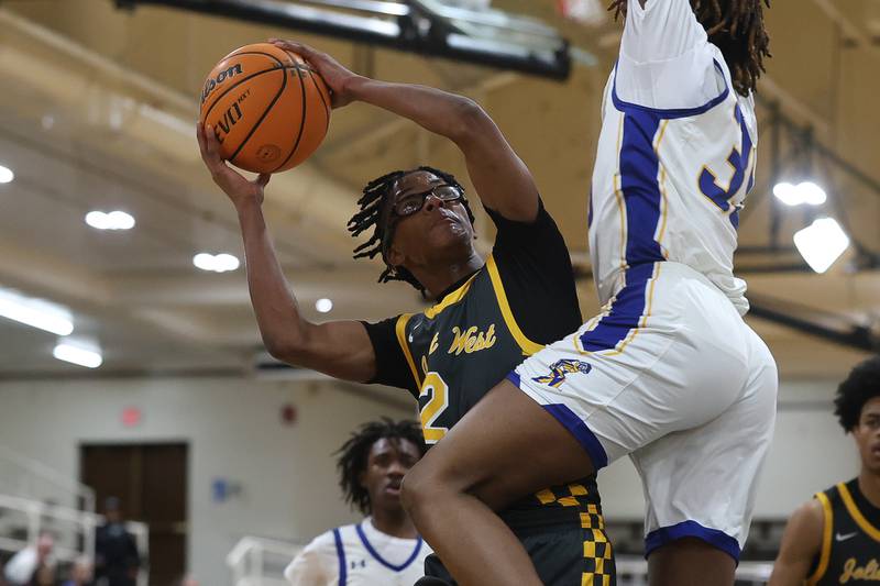 Joliet West’s Elijah Wilson draws the shooting foul against Joliet Central on Thursday, Jan. 15, 2026 in Joliet.