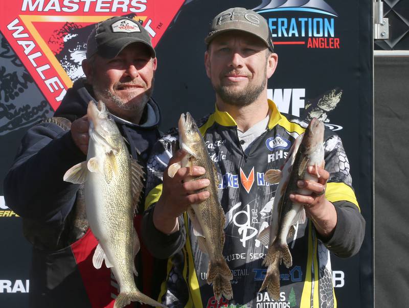 Jasen Schine and Eddie Michnewicz hold up their Walleye and Sauger fish during the National Walleye Tour Masters Walleye Circuit on Saturday, March 23, 2024 in Spring Valley.
