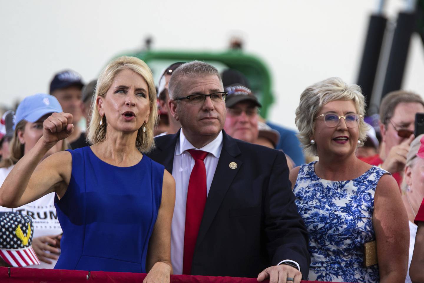 Republican U.S. Rep. Mary Miller, of Illinois, left, cheers next to Illinois state Sen. Darren Bailey at a rally where former President Donald Trump spoke, at the Adams County Fairgrounds in Mendon, Ill., Saturday, June 25, 2022. (Mike Sorensen/Quincy Herald-Whig via AP)