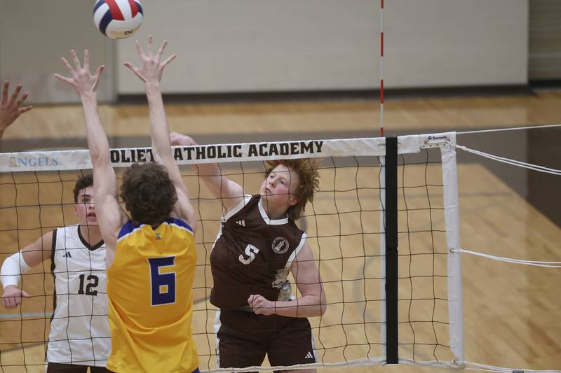 Joliet Catholic’s Nikolas Sporar hits a shot against Joliet Central on Wednesday, April 1, 2026 in Joliet.