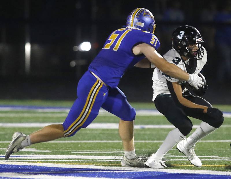 Johnsburg's Chris Link tackles Woodstock North's Braeden Berner during a Kishwaukee River Conference football game on Friday, Sept. 26, 2025, at Johnsburg High School.