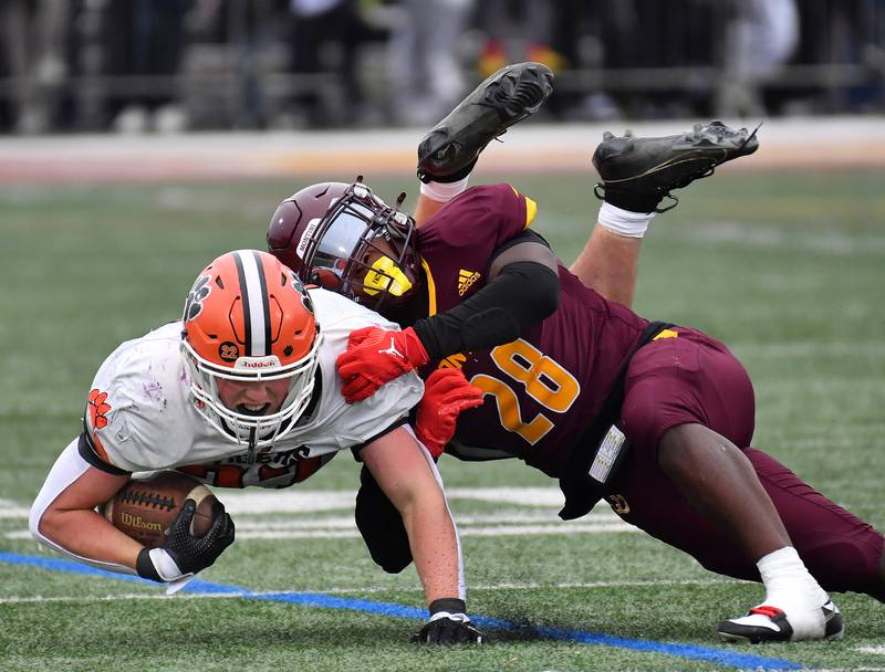 Montini's Isaac Alexander (28) makes an open field tackle on Byron's Caden Considine during a Class 3A second-round game on November 9, 2024 at Montini Catholic High School in Lombard.