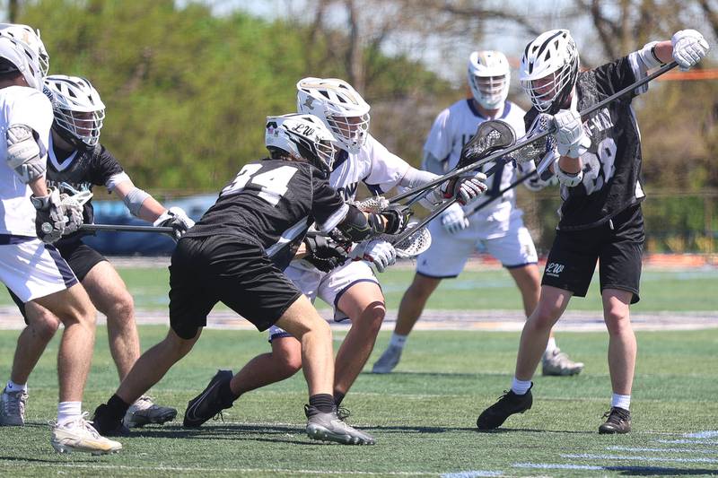 Lemont’s Jack Tyszkiewicz battles off a host of defenders against Lincoln-Way on Saturday, April 25, 2026 in Lemont.