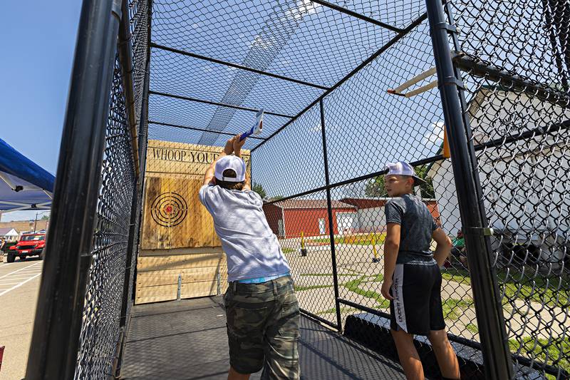 CJ Lawson (left), 11, and Kyhlor Thomas, 10, both of Tampico try their luck at the Whoop Your Axe booth Saturday, July 22, 2023 at Tampico Days.
