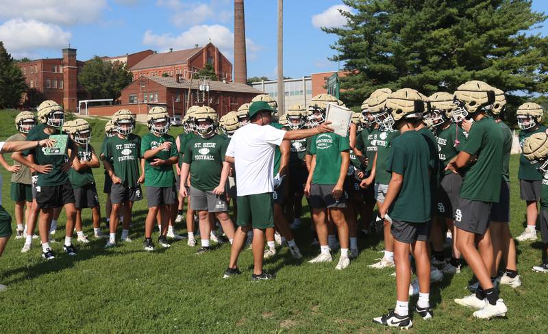 St. Bede head coach Jack Brady gathers his team before practice during the first day of football practice on Monday, Aug. 11, 2025 at St. Bede Academy.