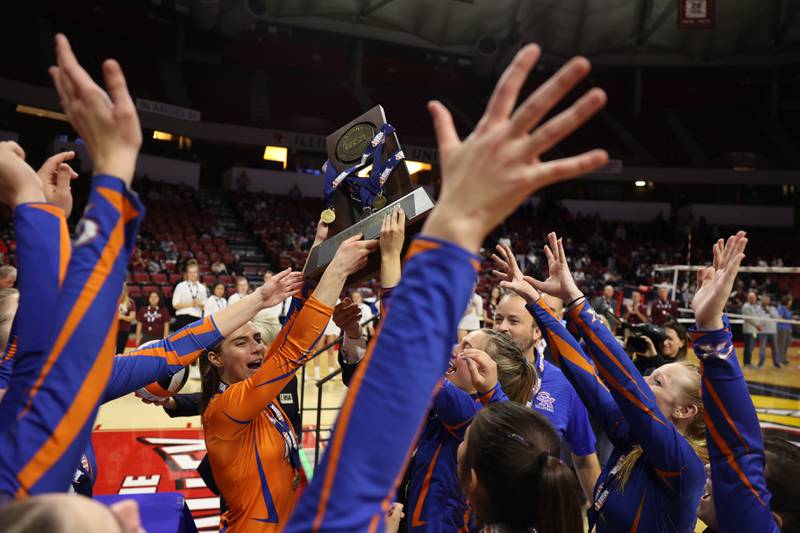 Genoa-Kingston receive the championship trophy after a two set win over IC Catholic in the Class 2A championship match on Saturday in Normal.