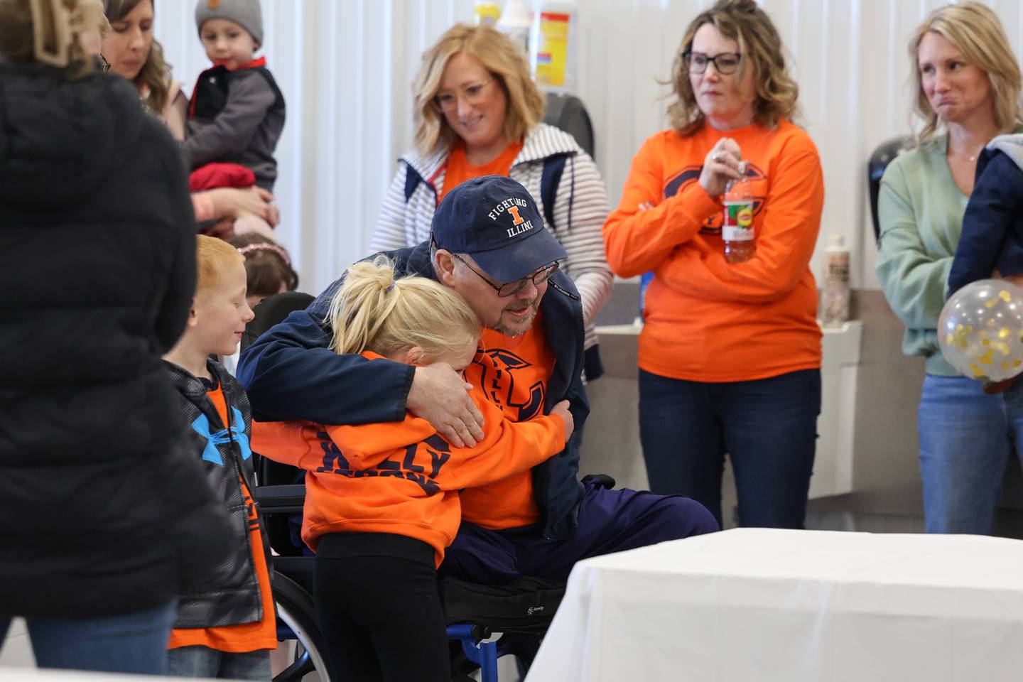Willy VanWassenhove receives a hug from 6-year-old Ryleigh Foltz, of Cabery, as he arrives to a welcome home event at the Cabery Fire Department on Saturday, March 22, 2025.