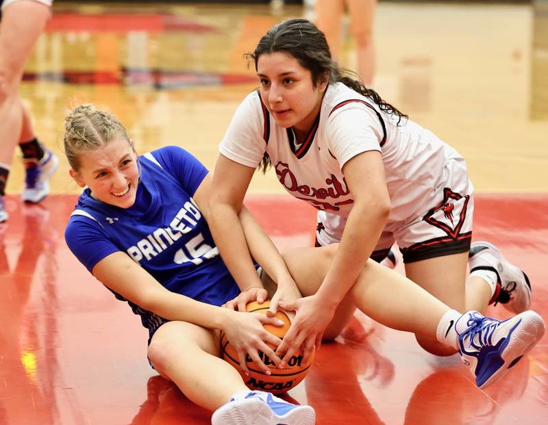 Princeton's Ava Munson (left) and Hall's Natalia Zamora tussle for the ball Thursday night in Spring Valley. the Tigresses won 48-28.