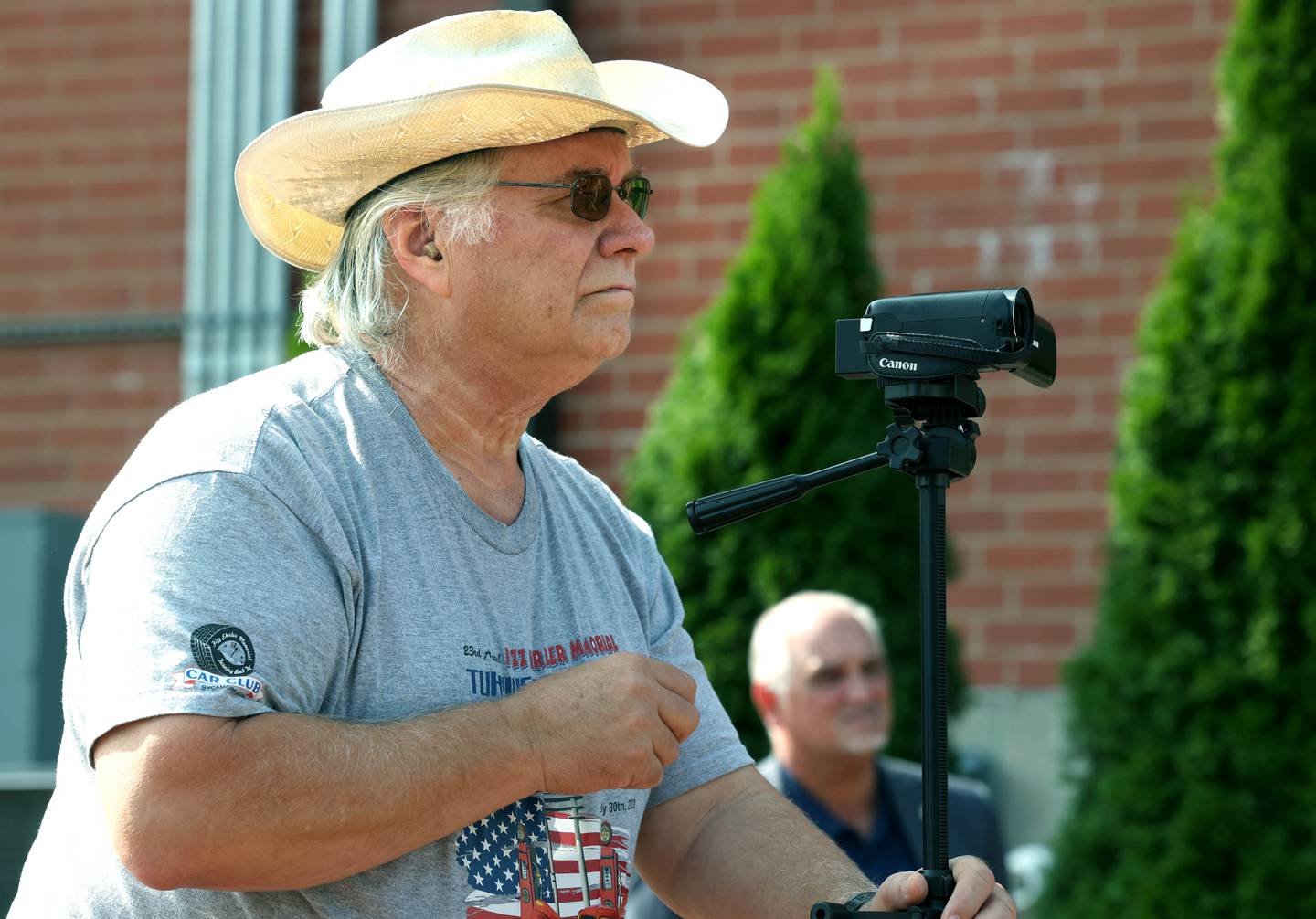 Mike Tritle, from DeKalb, shoots video Thursday, Aug. 22, 2024, during the DeKalb Veterans Memorial Mural dedication in Van Buer Plaza in DeKalb. Tritle captures the stories of veterans on video during at community events in the area.