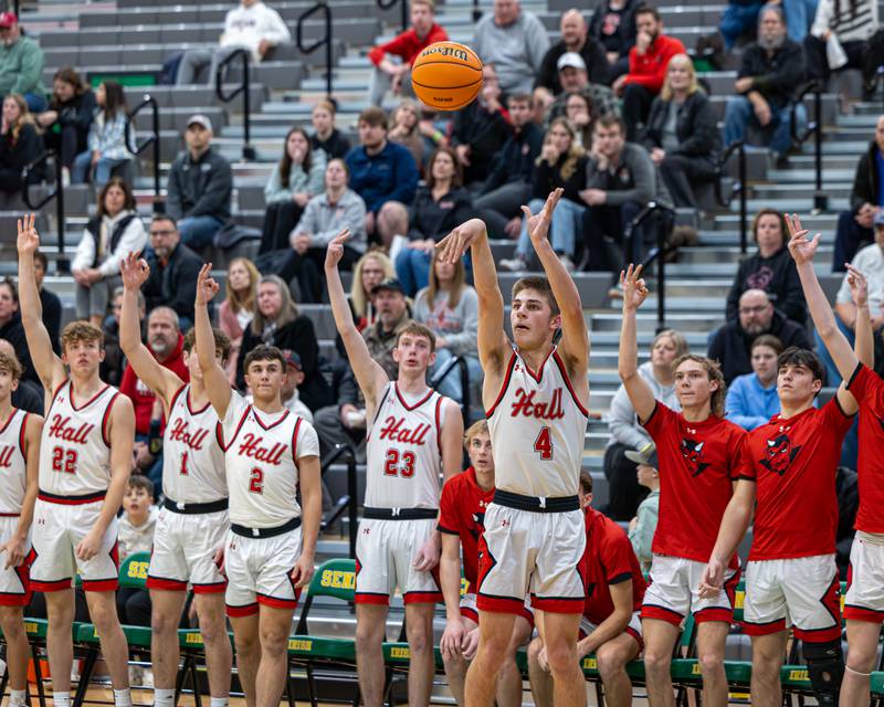 Luke Bryant (4) of Hall shoots 3-point shot as teammates put up 3 fingers on bench during game in the Shipyard Showdown on Tuesday, December 23, 2025 at Seneca High School in Seneca.
