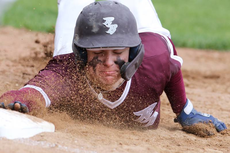 Richmond-Burton's Hayden Christiansen slides safely back into first base after being checked by Grayslake Central during their baseball game on Saturday, May 1, 2021, at Richmond-Burton High School in Richmond.