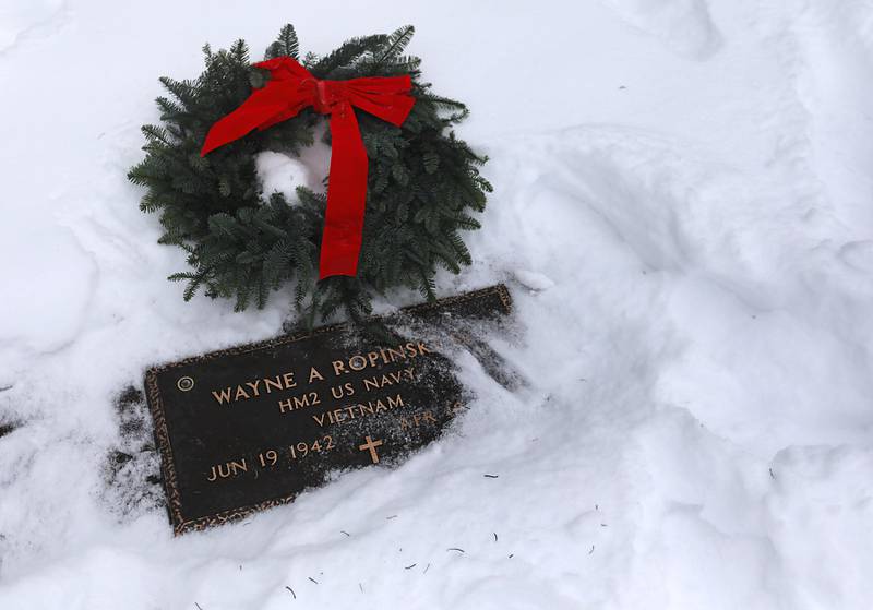 A wreath lays a the gravesite of veteran Wayne Ropinski Sr. after McHenry's Wreath Laying Ceremony in honor of fallen veterans on Friday, Dec. 5, 2025,, at St. Mary's Catholic Cemetery in McHenry. The event was hosted by McHenry American Legion Post 491 and Team Home Depot.