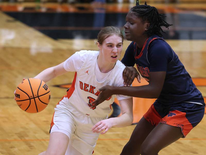 DeKalb's Olivia Schermerhorn drives against Oswego's Madelyn-Jordyn Mensah during their game Monday, Jan. 5, 2026, at DeKalb High School.