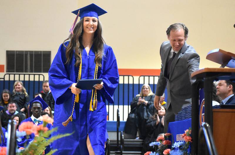 Bailey Botterman smiles after receiving her diploma from Genoa-Kingston School Board President Matt Krueger during the graduation ceremony Saturday, May 20, 2023, at Genoa-Kingston High School.