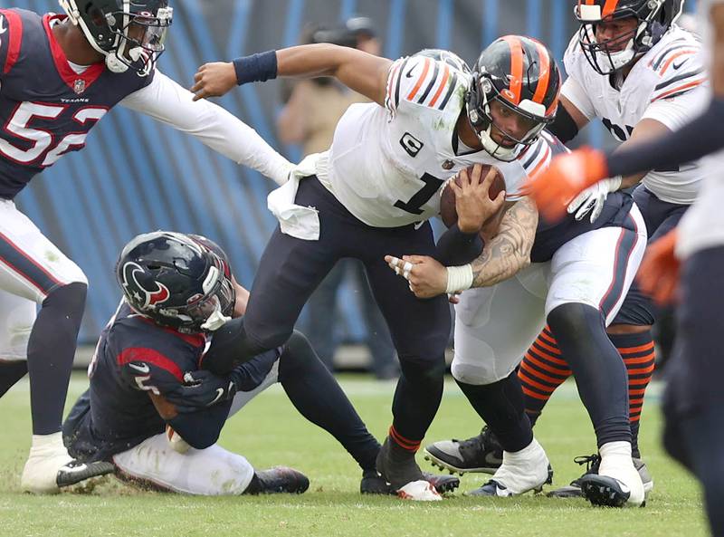 Chicago Bears quarterback Justin Fields tries to pull away from Houston Texans safety Jalen Pitre during their game Sunday, Sept. 25, 2022, at Soldier Field in Chicago.