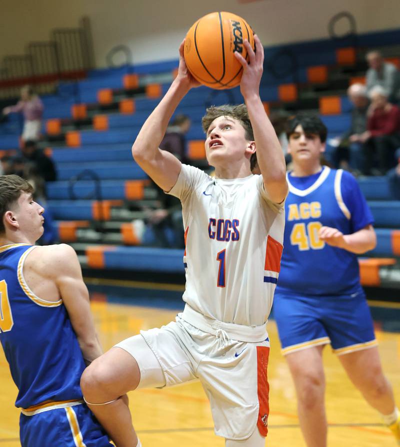 Genoa-Kingston's Kash Sunderlage scores over a Aurora Central Catholic defender Monday, Feb. 23, 2026, during their IHSA Class 2A regional quarterfinal at Genoa-Kingston High School.