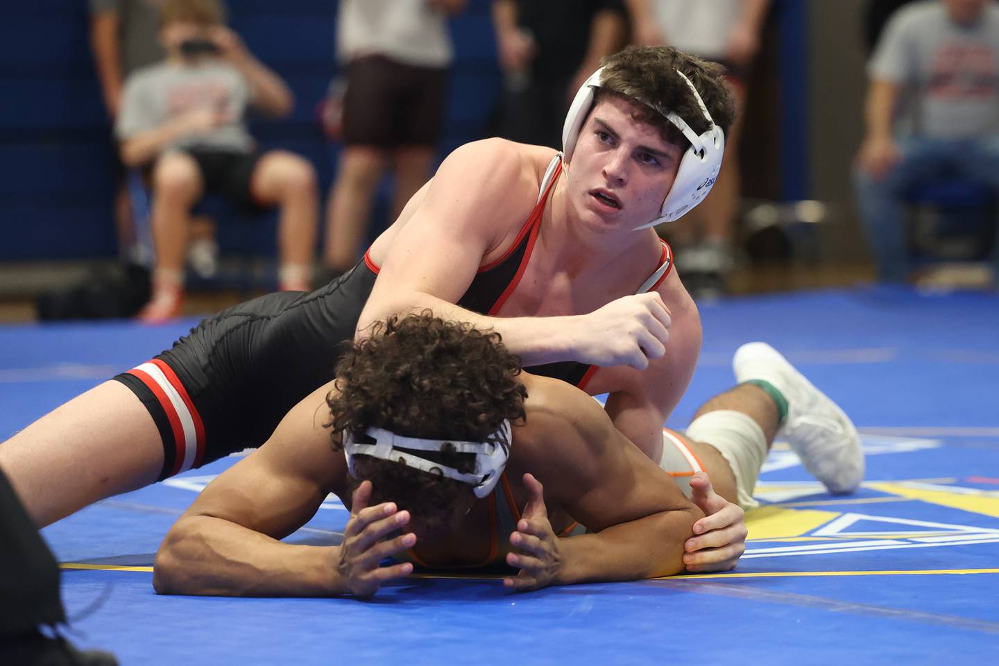 Lincoln-Way Central’s Tim Key looks to his coach as he holds down Romeoville’s Mason Gougis in the Joliet Central McLaughlin Classic on Saturday, Dec. 2, 2023 in Joliet.