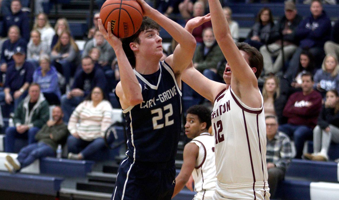 Wheaton Academy’s Ben DeHaan, right, guards Cary-Grove’s Adam Bauer during Class 3A Regional action in Cary Wednesday night.
