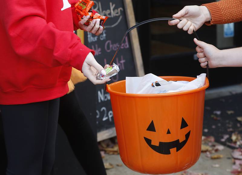 Candy is handed out to trick or treaters during Halloween on the Square on Thursday, Oct. 31, 2024, in Woodstock. The event featured trick and treating and a costume contest.